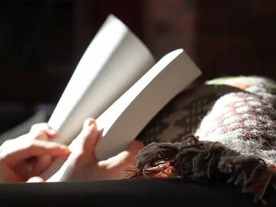 Des mains tiennent un livre ouvert